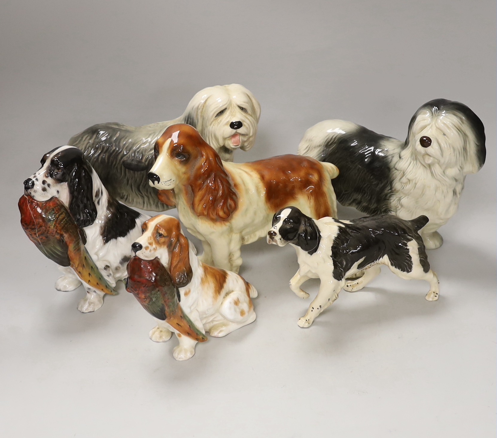 A group of six ceramic models of dogs including Royal Doulton and Beswick